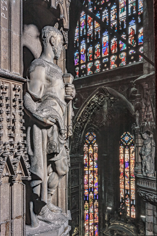  Duomo (the Cathedral), the pillar of the left transept: a capital and a statue.