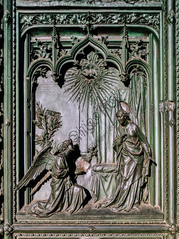  Cathedral, main portal: bronze panel by L. Pogliaghi, 1894-1908, depicting the Annunciation. 