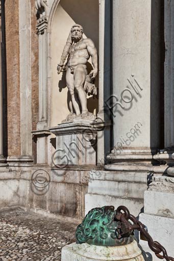 Modena, the Ducal Palace (seat of the Military Academy), detail of the façade in piazza Roma (Roma square): "Hercules", statue by Prospero Sogari (1565) and big mask in braze holding up a chain, by anonymous author (XVII century).