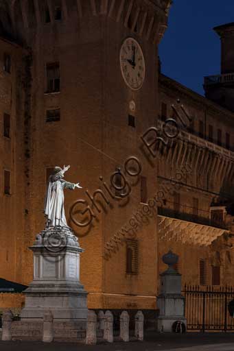 Ferrara: night view of the Castello Estense (the Estense Castle), also known as Castle of St. Michael. In the foreground, the statue of the Ferrara friar Girolamo Savonarola.