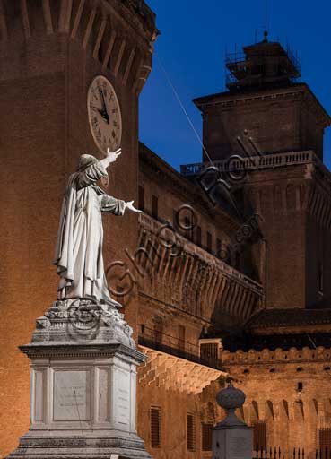 Ferrara: night view of the Castello Estense (the Estense Castle), also known as Castle of St. Michael. In the foreground, the statue of the Ferrara friar Girolamo Savonarola.