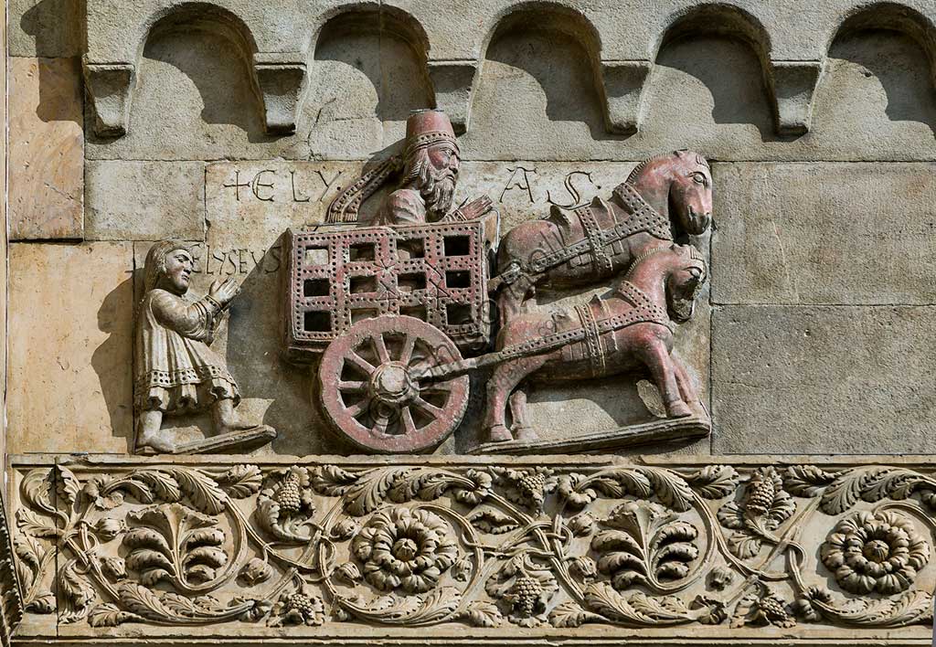 Fidenza, Duomo (St. Donnino Cathedral), Façade: the bas-relief with "The prophet Elijah abducted to heaven with his chariot and followed by Elisha, his main disciple". Work by Benedetto Antelami and his workshop.