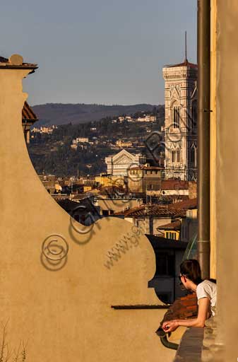   Florence: city view from Piazza Santo Spirito. In the foreground, part of the façade of the church of Santo Spirito. In the background, the bell tower by Giotto.