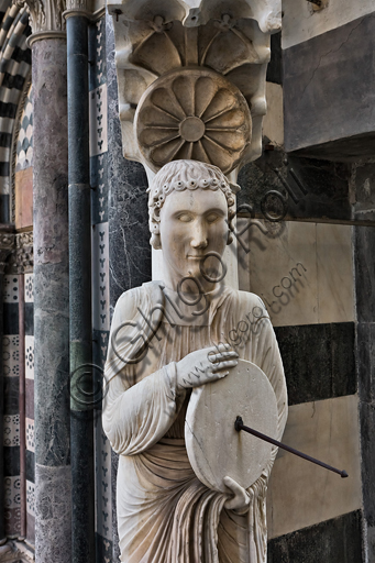 , Genoa, Duomo (St. Lawrence Cathedral),  the façade, corner between the west and the south side: "Saint with sundial known as the Knife Grinder (St. John the Evangelist?), about 1225.Detail.