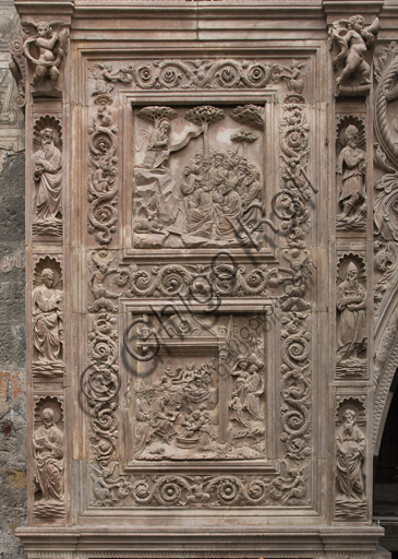 Genoa, Duomo (St. Lawrence Cathedral), inside, Chapel of St. John the Baptist, the front elevation: tiles with episodes of the life of Saint John the Baptist (St. John preaches to his disciples on the banks of the Jordan, and Birth of St. John), sculptural reliefs by Domenico, Elia and Giovanni Gagini (c. 1448-1450).