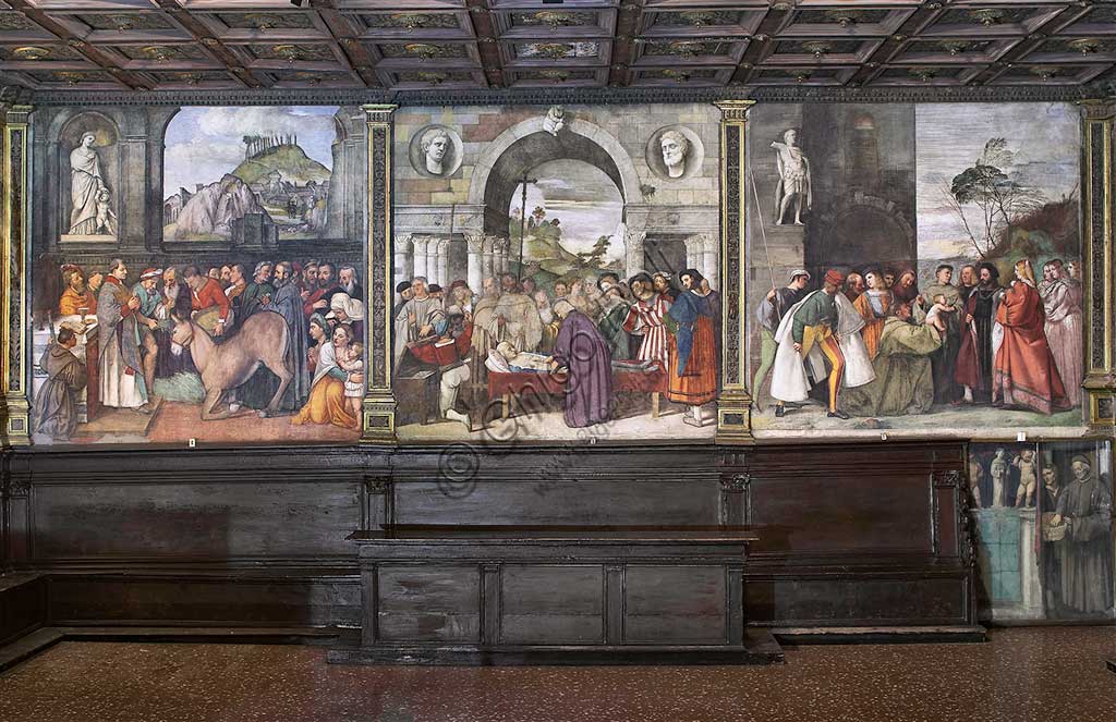 Padova, Basilica di Sant'Antonio o del Santo, Scuola del Santo, Salone: veduta della parete nord. Da sinistra, affreschi:-   “Il miracolo della mula", di Girolamo Tessari, detto Girolamo dal Santo, 1515-  “Il cuore dell'avaro nello scrigno", di Francesco Vecellio, 1512- “il neonato proclama l’innocenza della madre", di Tiziano Vecellio, 1511.