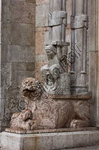 Ferrara, the Cathedral dedicated to St. George, façade: detail with lion and telamon supporting the prothyrum.