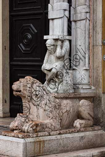 Ferrara, the Cathedral dedicated to St. George, façade: detail with lion and telamon supporting the prothyrum.
