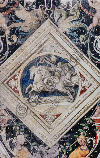 The Piccolomini Library, the vault: spandrel above the north-east wall between the first and the second story, frescoes attributed to Girolamo del Pacchia, Giacomo Pacchiarotto and Littifredi Corbizi. The decoration is inspired by the Domus Aurea and the motif of the ancient grotesques. The general scheme of the vault is probably due to Bernardino di Betto, known as Pinturicchio. At the centre grisaille with  a scene of a battle. Detail.