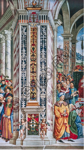 Libreria Piccolomini, parete sud-ovest: pilastro angolare tra  la settima e la ottava delle dieci storie riguardanti Enea Silvio Piccolomini, futuro papa Pio II, (1503 - 1508), affreschi di Bernardino di Betto, detto il Pinturicchio. Nel dado, l’arme Piccolomini sormontata dalla tiara pontificia fra due putti reggi stemma.