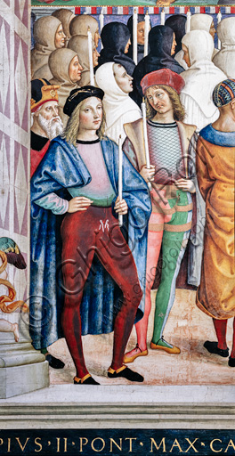 Libreria Piccolomini, parete sud-ovest: “Pio II canonizza S. Caterina da Siena, 29 giugno 1461”, la nona delle dieci storie riguardanti Enea Silvio Piccolomini, futuro papa Pio II, (1503 - 1508), affresco di Bernardino di Betto, detto il Pinturicchio.Particolare: in basso a sinistra due uomini che recano ceri sono probabilmente l’autoritratto di Pinturicchio e il ritratto di Raffaello.