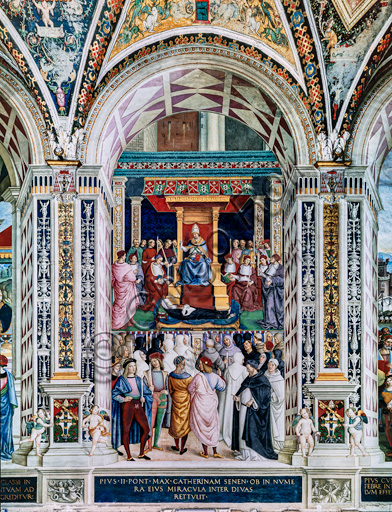 The Piccolomini Library, south west wall: “ Pius II canonizes St. Catherine of Siena, June 29, 1461”, the ninth one of the ten stories about Aeneas Sylvius Piccolomini, future Pope Pius II, (1503 - 1508), fresco  by Bernardino di Betto, known as Pinturicchio. In the left background, two onlookers holding candles are presumed portraits of Raphael and Pinturicchio.