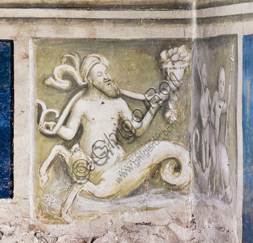 The Piccolomini Library, south-west wall: scene representing a triton bearing a cornucopia, grisaille below the pilaster between  the tenth scene and the north-west wall.