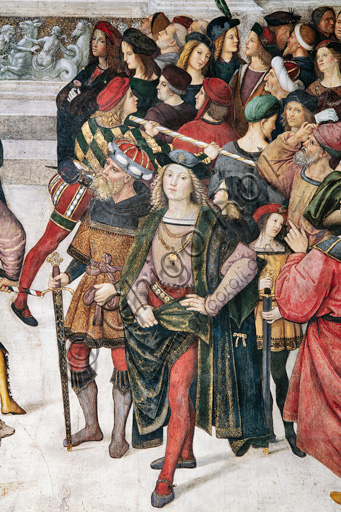 Libreria Piccolomini, registro superiore esterno: “Incoronazione di Pio III (8 ottobre 1503)”, affresco di Bernardino di Betto, detto il Pinturicchio. Particolare con la folla di spettatori tenuta a freno da una guardia e bellissimo giovane vestito con grande eleganza.