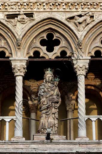 Ferrara, the Cathedral dedicated to St. George, façade: detail of the small loggia with twin bed windows and "Madonna and Child", a clay statue by Cristoforo da Firenze (1427).