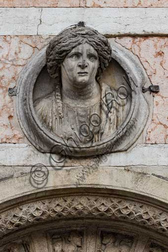 Ferrara, the Cathedral dedicated to St. George, façade: detail with Roman female bust , known as "Madonna of Ferrara"