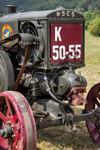 Old Tractor. Detail.Make: HSCS (Hofherr - Schrantz - Clayton - Shuttleworth)Model: K44-48Year: 1938 - 1942Fuel: crude oil and/or diesel oilNumber of Cylinders: Displacement: about 10.600 ccHorse Power: 44 HP at the wheel and 48 HP  at the PTO (Power Take-Off)Characteristics: 2-stroke diesel cycle. It had been used in the Second World War to pull the cannons, but then it was abandoned because it made too much noise and signaled the vehicle to the enemies.