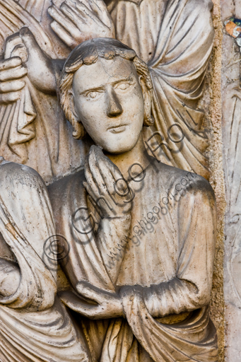 , Genoa, Duomo (St. Lawrence Cathedral), West side, the façade, the main doorway: detail of the lunette with "The Martyrdom of St. Lawrence", by Master of lunette of the Genoa Cathedral, 1225.Detail of a bystander observing the martyrdom.