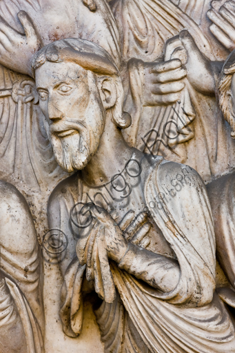 , Genoa, Duomo (St. Lawrence Cathedral), West side, the façade, the main doorway: detail of the lunette with "The Martyrdom of St. Lawrence", by Master of lunette of the Genoa Cathedral, 1225.Detail of a bystander observing the martyrdom.