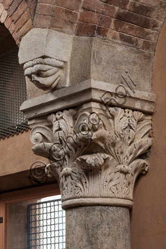 Modena, Ghirlandina Tower, Torresani Hall, east wall: a Corinthian capital with a sculpted face in the abacus protome.