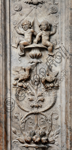 The Piccolomini Library, the exterior marble façade, pilaster: detail of a vase with grotesque motifs with winged putti, birds and cornucopias, by Lorenzo di Mariano Fucci, known as Marrina, and assistant.