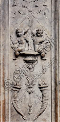 The Piccolomini Library, the exterior marble façade, pilaster: detail of a vase with grotesque motifs with winged putti and torche,. by Lorenzo di Mariano Fucci, known as Marrina, and assistant.