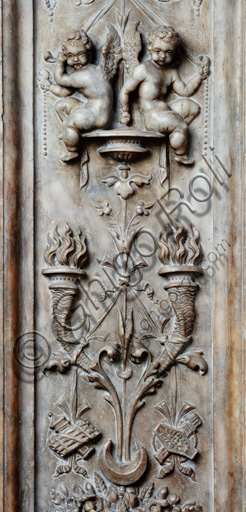 The Piccolomini Library, the exterior marble façade, pilaster: detail of a vase with grotesque motifs with winged putti and torche,. by Lorenzo di Mariano Fucci, known as Marrina, and assistant.