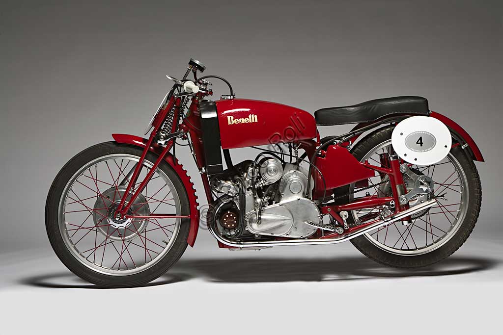 Moto d'epoca Benelli 250 Corsa 4 Cilindri con CompressoreMarca: Benellimodello: 250 Corsa 4 Cilindri con Compressorenazione: Italia - Pesaroanno: 1942condizioni: restauratacilindrata: 248,2 (alesaggio e corsa 41 x 47)motore: quattro cilindri con compressorecambio: in blocco a quattro rapportiAnche la forma del manubrio, che ricorda le corna di un toro, sembra voler sottolineare la potenza, realmente mostruosa per i tempi, di questa Benelli da competizione. Grazie a un compressore Cozette, azionato da ingranaggi innestati sul cambio, la 250 quattro cilindri sprigionava 55,2 Hp a 13.000 giri e, a dispetto della cilindrata di soli 250 cc, raggiungeva i 230 km/h. Concepita nel '39 fu prodotta in pochissimi esemplari di cui questo sembra l'unico superstite. A causa della guerra non partecipò a nessuna competizione e rimane uno degli esempi più alti delle capacità tecniche dell'industria motociclistica di quell'epoca.