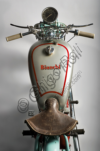 Vintage motorcycle “Bianchi Freccia Azzurra 500 Corsa”.Brand: Bianchi. model: Blue Arrow 500 Corsa. country: Italy - Milan. year: 1939. conditions: restored. displacement: 496 (bore and stroke 82 x 94). engine: single cylinder, four stroke. gearbox: separate four-speed.  Edoardo Bianchi, born in 1865, orphan raised by the "Martinitt" in Milan, made all the stages, none excluded, from the apprentice to the manufacturer of prestigious cars.  He built bicycles, De Dion Bouton motor tricycles, introduced pneumatic tires invented by Dunlop into Italy, built motor bicycles and finally some of the most beautiful motorcycles in Italian production.  Bianchi's name is forever linked to the glorious competitive season of the 1920s, when her motorcycles left very little space for competitors. Drivers like Alberto Ascari, Achille Varzi and Tazio Nuvolari drove them. The Blue Arrow was a project by the brilliant Mario Baldi and was the first to introduce the twin-shaft overhead distribution on a racing bike. The specimen reproduced in these pages was built only in three units. On one of these races Alberto Ascari ran.