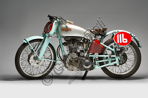 Vintage motorcycle “Bianchi Freccia Azzurra 500 Corsa”.Brand: Bianchi. model: Blue Arrow 500 Corsa. country: Italy - Milan. year: 1939. conditions: restored. displacement: 496 (bore and stroke 82 x 94). engine: single cylinder, four stroke. gearbox: separate four-speed.  Edoardo Bianchi, born in 1865, orphan raised by the "Martinitt" in Milan, made all the stages, none excluded, from the apprentice to the manufacturer of prestigious cars.  He built bicycles, De Dion Bouton motor tricycles, introduced pneumatic tires invented by Dunlop into Italy, built motor bicycles and finally some of the most beautiful motorcycles in Italian production.  Bianchi's name is forever linked to the glorious competitive season of the 1920s, when her motorcycles left very little space for competitors. Drivers like Alberto Ascari, Achille Varzi and Tazio Nuvolari drove them. The Blue Arrow was a project by the brilliant Mario Baldi and was the first to introduce the twin-shaft overhead distribution on a racing bike. The specimen reproduced in these pages was built only in three units. On one of these races Alberto Ascari ran.