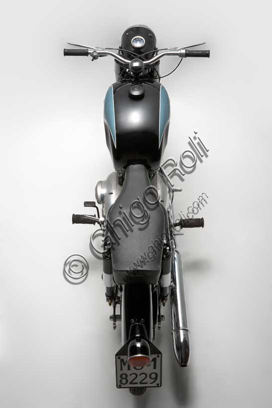 Vintage motorcycle “Maserati 250 T4”Brand: Maseratimodel: 250 T4country: Italy - Modenayear: 1956condition: restoreddisplacement: 246.17 (bore and stroke 70 x 64)engine: Single-cylinder with overhead valvesgearbox: four-speedThe 250, presented in 1954, is the last motorcycle to be produced by the “Fabbrica Candele e Accumulatori Maserati” before the Modena factories of the trident definitively converted to the production of cars. Umberto Panini, the owner of this model, worked at Maserati in those years and wanted to preserve this memory. The T4 presents notable technical refinements: it is the first production motorcycle with dual ignition and has twin-helical gears in the distribution. It had a rather calm nature (it did not exceed 120 km/h) and a good linearity of power delivery, but it was not successful and no more than 200 examples were produced. The surviving ones are rare.