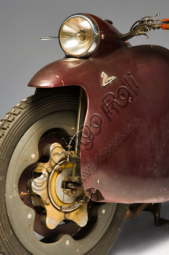 Vintage motorbike Mayor.Brand: Mayorcountry: Italy - Turinyear: 1947conditions: preserveddisplacement: 349.3 cc. (bore and stroke 76 x 77)engine: vertical single cylinder with overhead valvesgearbox: four-speed with pedal controland final shaft transmissionOne of the most futuristic projects in the history of the motorcycle is due to Salvatore Maiorca, (hence the name of the motorcycle), a brilliant engineer well known in Turin. The Mayor, of which this unique prototype survives, built in the Aeritalia workshops of the Fiat group and thought probably for the municipal police. It has load-bearing and enveloping bodywork that integrates the headlight and mudguards, indirect steering, forced air-cooled aeronautical engine, longitudinal crankshaft that extends in the block gearbox and the shaft transmission. But the most innovative feature for which the Mayor will be remembered, even if it did not follow, are the elastic wheels: a steel disc joins the outer rim to the internal hub by means of rubber pads ensuring, at least in theory, the springing of the motorcycle without the need for other suspension.