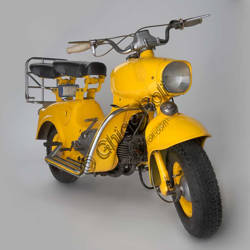 Vintage Motorcycle (Scooter) “Rumi Formichino”Brand: Fonderie Officine Rumimodel: Formichinocountry: Italy - Bergamoyear: 1955 - 6condition: restoreddisplacement: 124.6 (bore and stroke 42 x 45)engine: two-stroke horizontal twin-cylindergearbox: four-speed blockIn the wake of the success of the Vespa and Lambretta, Rumi felt the need to produce its own scooter. The mythology of the house's admirers has it that the absolutely unique shape of the Formichino was shaped directly in clay by Donnino Rumi after having fixed the engine on two stands. In fact, the load-bearing body of this gigantic mechanical insect is cast in aluminum alloy in just two parts: the front one incorporates the tank, fork and headlight, the rear one everything else. It also had some success in competitions, winning the twenty-ninth Bol d'Or, which was followed by a small run of Formichinis with this name. From 1958, production was licensed