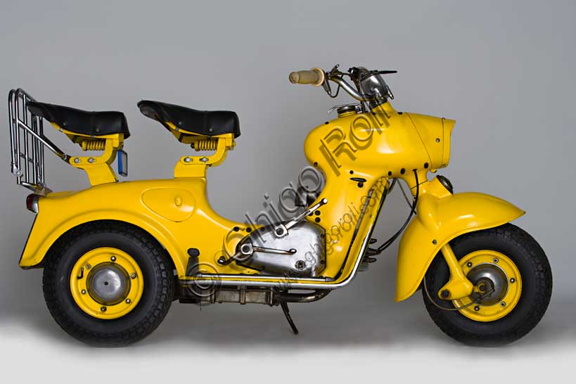 Vintage Motorcycle (Scooter) “Rumi Formichino”Brand: Fonderie Officine Rumimodel: Formichinocountry: Italy - Bergamoyear: 1955 - 6condition: restoreddisplacement: 124.6 (bore and stroke 42 x 45)engine: two-stroke horizontal twin-cylindergearbox: four-speed blockIn the wake of the success of the Vespa and Lambretta, Rumi felt the need to produce its own scooter. The mythology of the house's admirers has it that the absolutely unique shape of the Formichino was shaped directly in clay by Donnino Rumi after having fixed the engine on two stands. In fact, the load-bearing body of this gigantic mechanical insect is cast in aluminum alloy in just two parts: the front one incorporates the tank, fork and headlight, the rear one everything else. It also had some success in competitions, winning the twenty-ninth Bol d'Or, which was followed by a small run of Formichinis with this name. From 1958, production was licensed