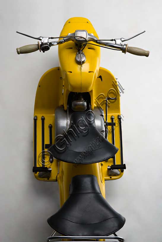 Vintage Motorcycle (Scooter) “Rumi Formichino”Brand: Fonderie Officine Rumimodel: Formichinocountry: Italy - Bergamoyear: 1955 - 6condition: restoreddisplacement: 124.6 (bore and stroke 42 x 45)engine: two-stroke horizontal twin-cylindergearbox: four-speed blockIn the wake of the success of the Vespa and Lambretta, Rumi felt the need to produce its own scooter. The mythology of the house's admirers has it that the absolutely unique shape of the Formichino was shaped directly in clay by Donnino Rumi after having fixed the engine on two stands. In fact, the load-bearing body of this gigantic mechanical insect is cast in aluminum alloy in just two parts: the front one incorporates the tank, fork and headlight, the rear one everything else. It also had some success in competitions, winning the twenty-ninth Bol d'Or, which was followed by a small run of Formichinis with this name. From 1958, production was licensed