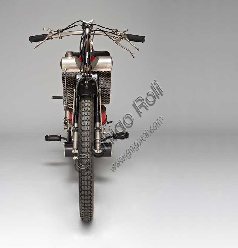 Vintage motorcycle “Scott Super Squirrel”Brand: Scottmodel: Super Squirrelcountry: United Kingdom - Shipleyyear: 1926 (?)condition: restoreddisplacement: 596engine: two-stroke twin-cylinder water-cooledgearbox: two-speedFounded in Shipley, Yorkshire, by Alfred Angus Scott, creator of more than fifty patents, the Scott factory produced motorcycles from 1909 to 1933. Several particularly innovative solutions were adopted in series production. The Scott was the first motorcycle to adopt water cooling. Some construction choices such as the open triangle frame, allowing the vehicle to be used by a female public, seemed to indicate the desire to address a “relaxed” user base. Despite this, the Scott soon proved to be a fast and efficient motorcycle, collecting numerous sporting successes. It reached 105 km/h. It won the Tourist Trophy in 1912 and 1913.