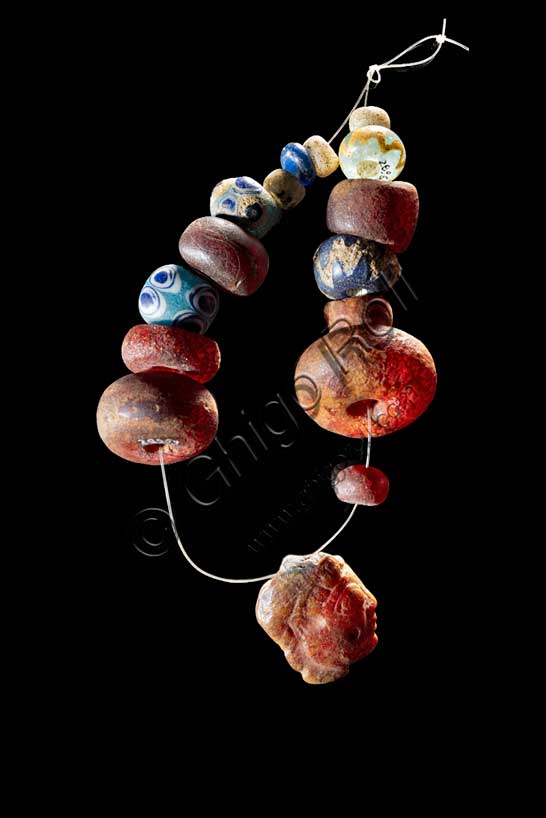 Museo Civico Archeologico di Bologna:  collana con vaghi in ambra e vetro e pendaglio configurato in ambra, dalla tomba 350 del sepolcreto della Certosa.Inv.  28958 e 28967