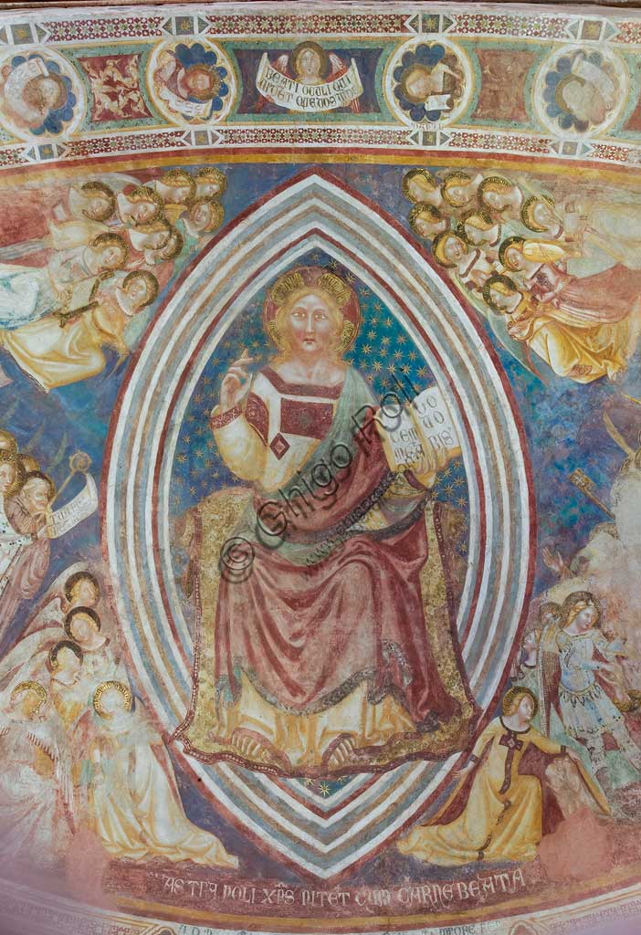 Codigoro, the Pomposa Abbey, interior of the Basilica of Santa Maria, apse: fourteenth-century frescoes by Vitale da Bologna, depicting Christ in majesty with angels and saints. Detail of blessing Christ in majesty within the almond and holding the book with the words "pacem meam do vobis" in his left hand.