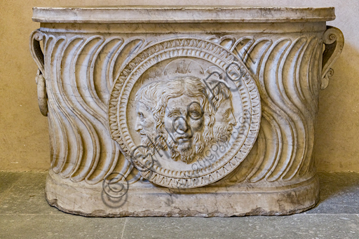  Pagno di Lapo Portigiani (workshop of Michelezzo), central nucleus of altar with the Trinity depicted in the centre, (1449-1452), marble, from the temple of the church of the Santissima Annunziata and inserted on the front of a funeral urn of Roman times.