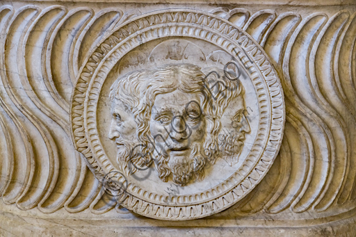  Pagno di Lapo Portigiani (workshop of Michelezzo), central nucleus of altar with the Trinity depicted in the centre, (1449-1452), marble, from the temple of the church of the Santissima Annunziata and inserted on the front of a funeral urn of Roman times.Detail.