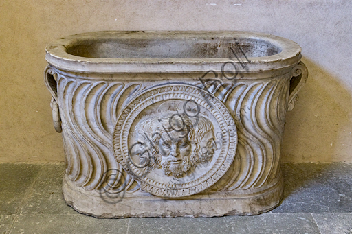  Pagno di Lapo Portigiani (workshop of Michelezzo), central nucleus of altar with the Trinity depicted in the centre, (1449-1452), marble, from the temple of the church of the Santissima Annunziata and inserted on the front of a funeral urn of Roman times.