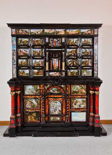 Palermo, The Royal Palace or Palazzo dei Normanni (Palace of the Normans), The Royal Apartment, The Monetiere Room (next to the Chinese Room): the Monetiere, i.e. the wooden cabinet with an ebony veneer, and inlays in tortoise, red lacquers and gilded bronze. Painted glass panels with biblical, mythological and allegorical scenes. Sicilian cabinetmakers, XVII century.