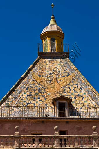 Palermo, The Royal Palace or Palazzo dei Normanni (Palace of the Normans): the Porta Nuova Tower and its pyramidal roof covered with polychrome majolica tiles with the image of an eagle with spread wings, designed by the architect Gaspare Guercio in 1663. 