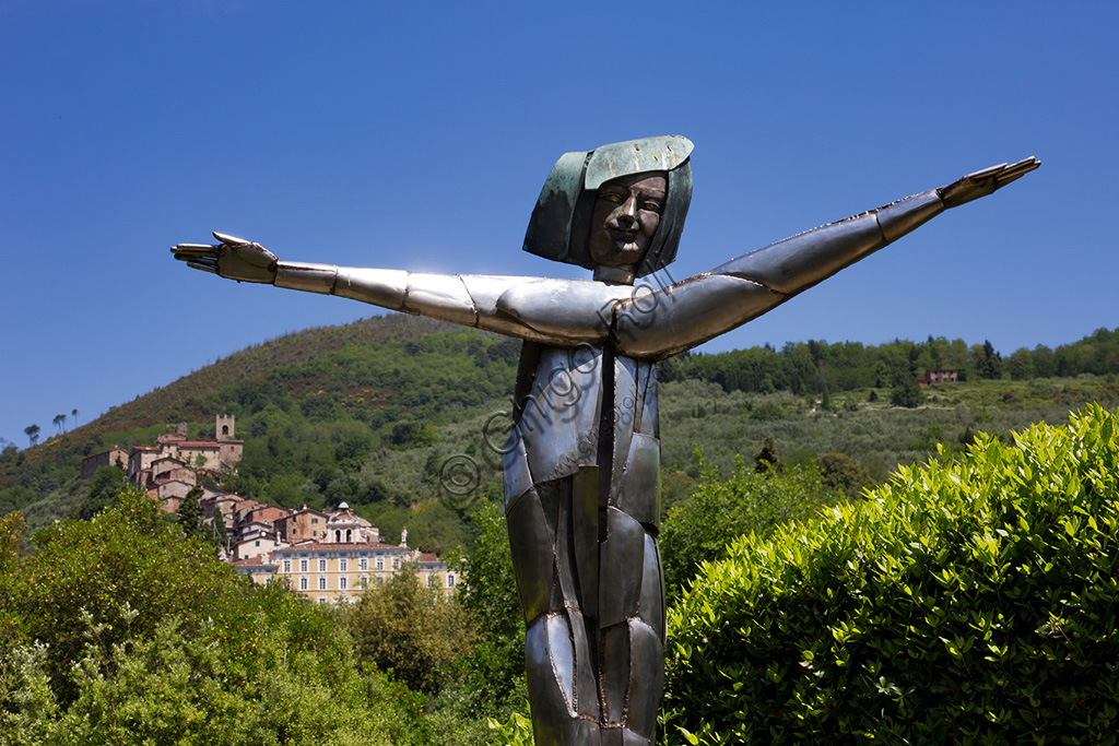 Pinocchio Park, the Land of Toys: the Fairy, bronze and steel statue by Pietro Consagra. In the background the facade of Villa Garzoni and the tiny village of Collodi.