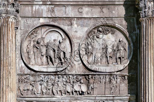  Rome, Roman Forum: Arch of Constantinus. Detail showing in the left medallion "Departure for the  Hunt", in the one on  the right "Sacrifice to Silvan", In the lower relief "Constantine besieging Verona". 3rd and 4th Century AD.