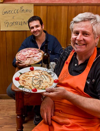 Piacenza, Osteria La Carrozza: Francesco and Paolo, two owners, with a cutting board of typical Piacenza cold-cuts and a dish with a "bortellina" (a sort of pancake without egg).