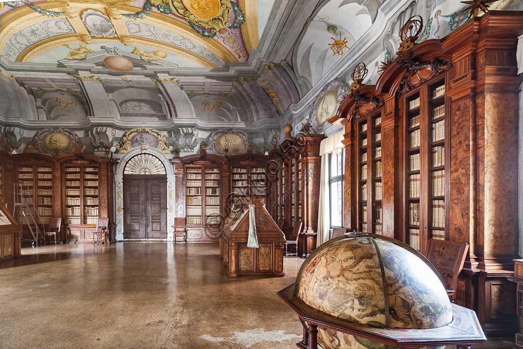 Pontificia Biblioteca Antoniana: veduta del Salone con mappamondo, librerie  e mobili contenenti corali miniati.