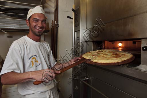  Recco, Moltedo traditional bakery: Lorenzo is  making the Recco focaccia bread, which is filled with stracchino cheese.