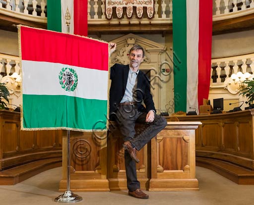 Reggio Emilia, the Town Hall Palace, the Council Room: Graziano Del Rio, mayor, beside the Italian flag.