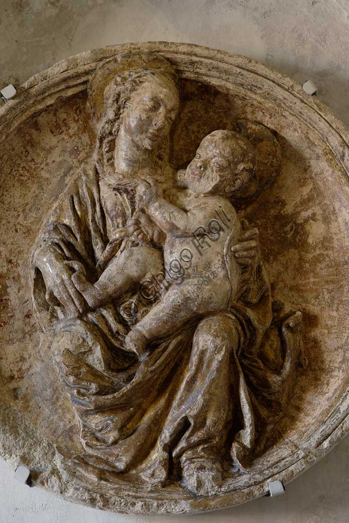 Vignola Stronghold, the niche above the door to the Contrari Chapel:  a tondo in scagliola (fifteenth-century style), depicting a Madonna with Child, in the variant called Madonna of Humility. Detail.